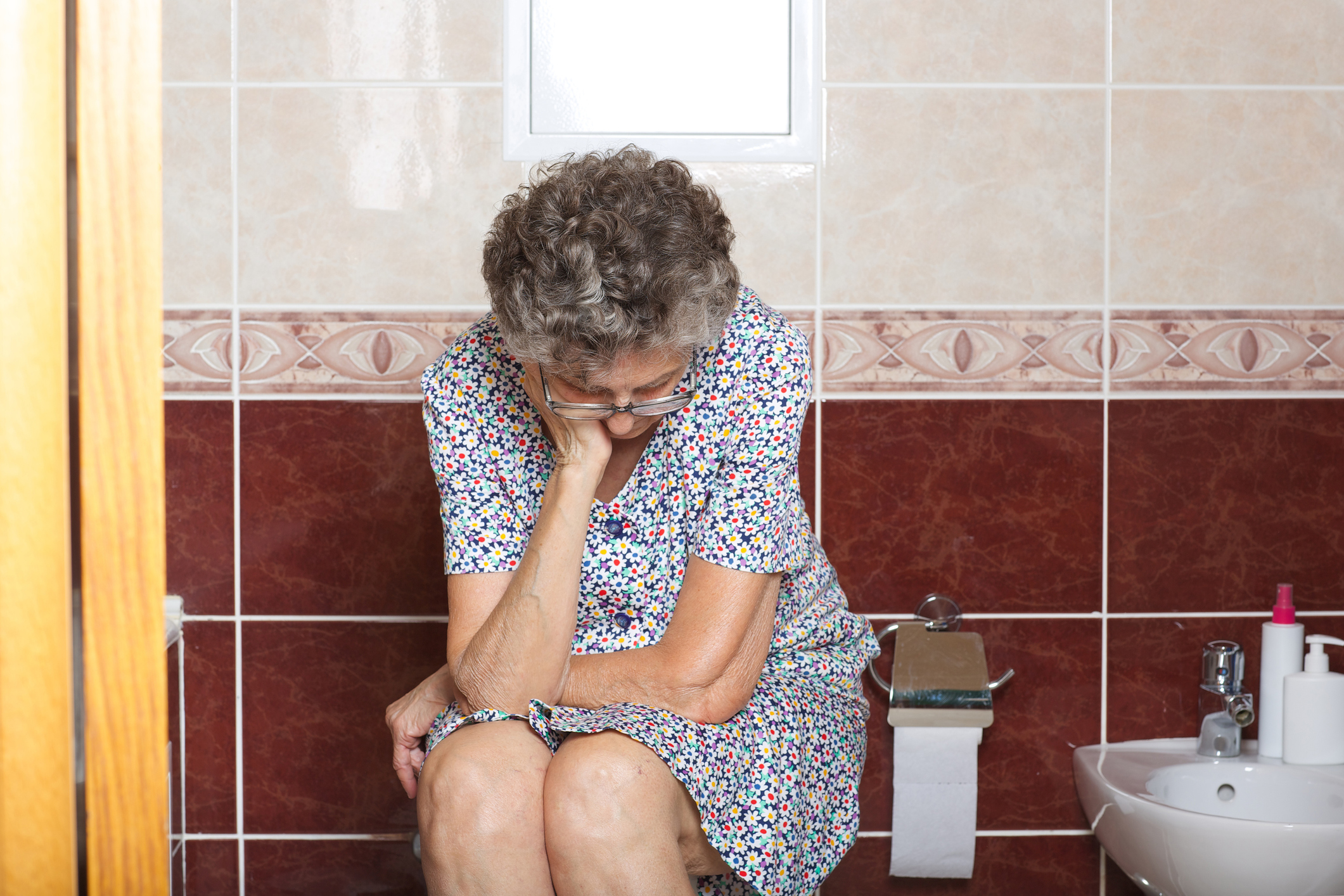 An elderly woman in bathroom