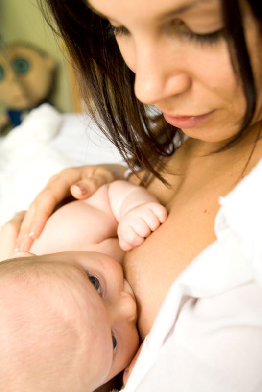 Image showing mother breastfeeding infant