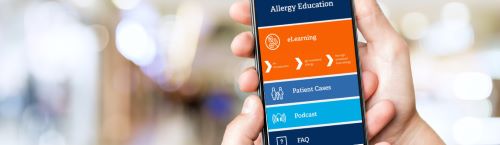 Photo of hand holding mobile phone with app