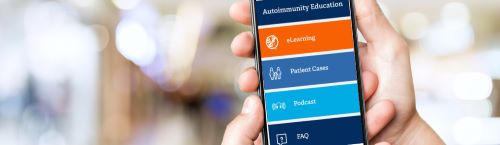 Photo of hand holding mobile phone with app