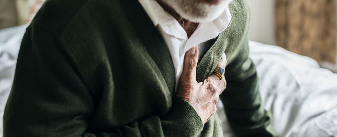 An man holding his arm on his heart