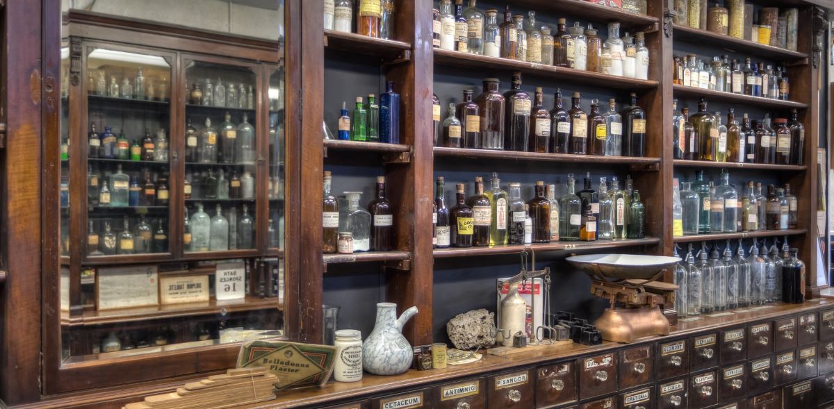 Historic pharmacy shelves stocked with medical bottles