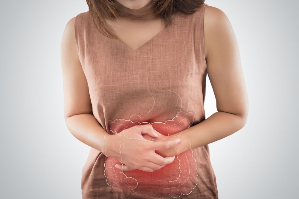 Woman holding abdomen 