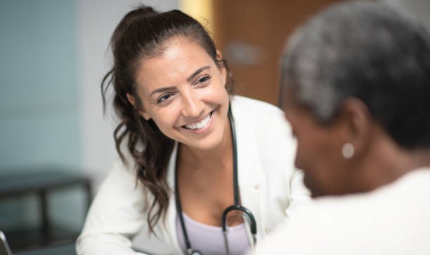 An image of two women smiling at a GP appointment. 