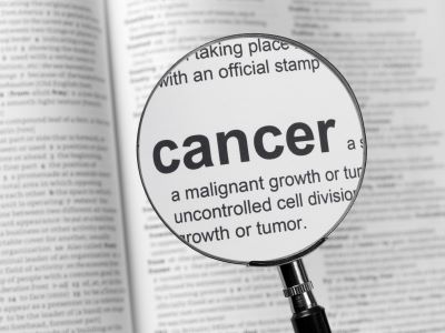 Book showing the word cancer magnified